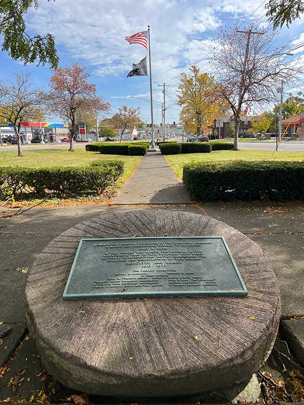 commemorative plaque and american flag in the village of liverpool